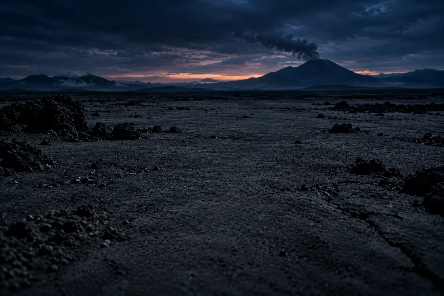 A wide plain of grey volcanic ash at dusk, a volcano smoking far away.